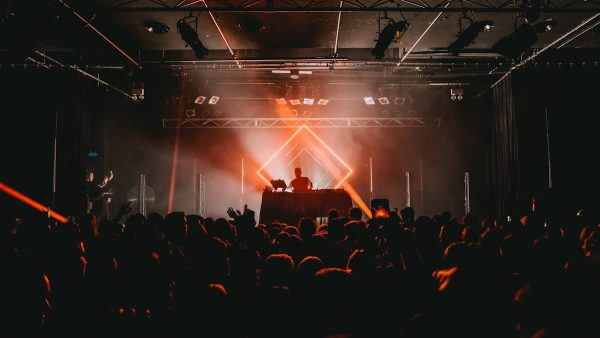 LED moving head spot light projecting beams at a concert