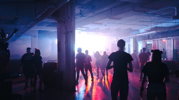 DJ performing at a nightclub with professional sound and lighting