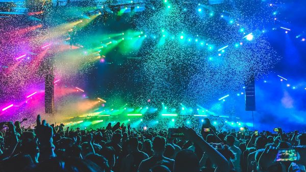 Outdoor concert with crowd and colorful stage lights